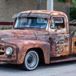 Photo of an old and rusted Ford pickup truck