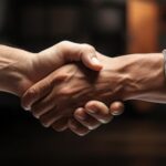 A handshake, reflecting the trucking industry's partnerships with those experiencing housing instability.