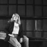 Black-and-white photo of NATCO Transport VP and co-owner Cori Eckley in a dark blazer and white T-shirt, and jeans.