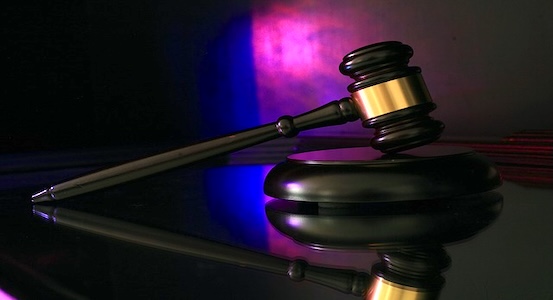 Gavel lit in blue and red, illustrating freight broker liability after the Montgomery ruling.